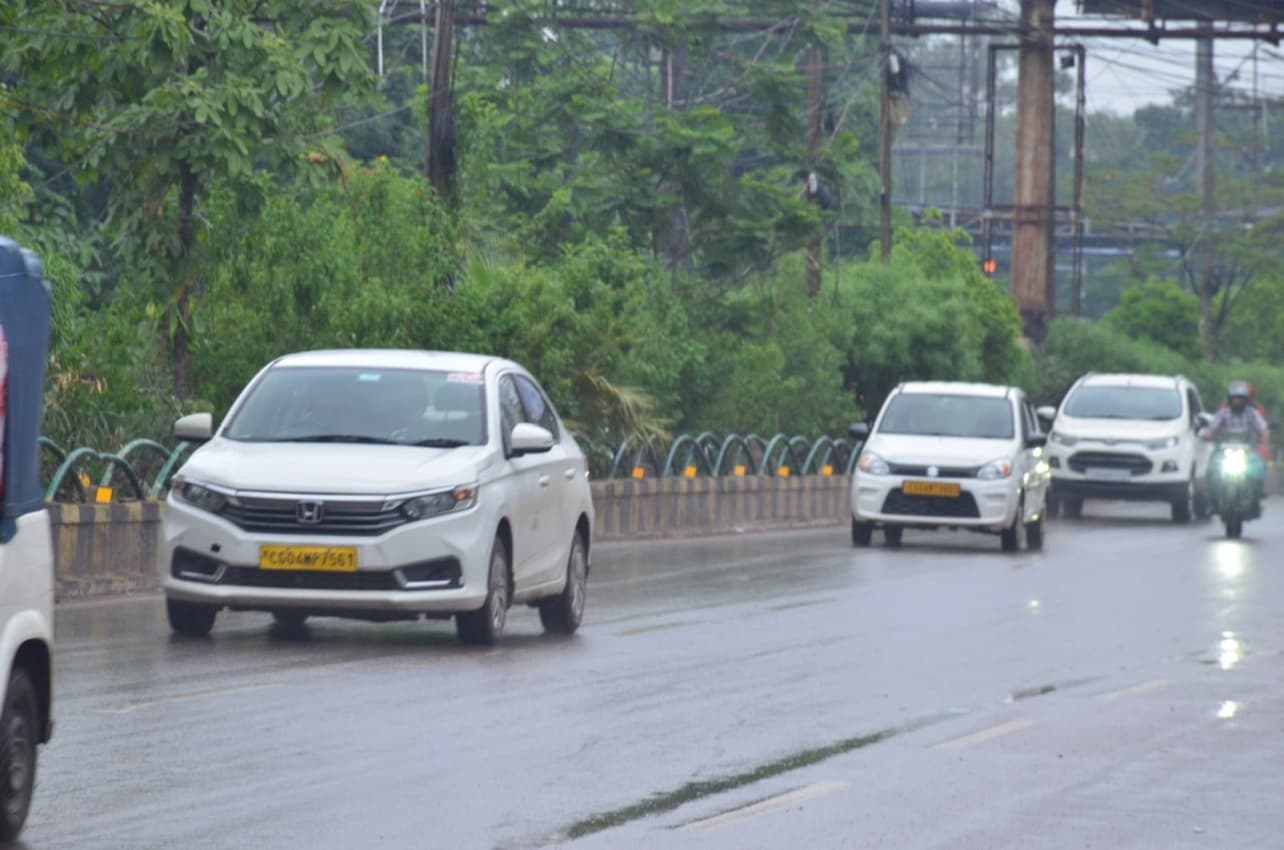 राजधानी रायपुर में रिमझिम के दौरान गुजरते वाहन। 